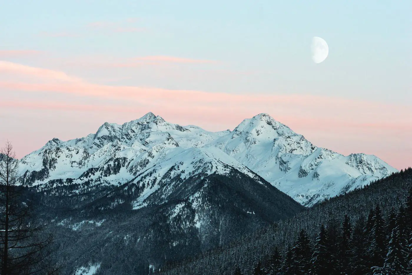 Snowy peaks under pastel sky
