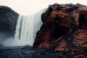 Waterfall beside red cliffs