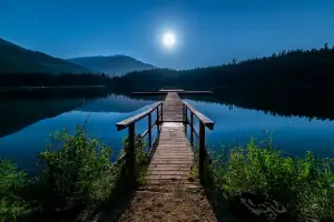 Wooden jetty on a moonlit lake