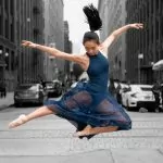 jumping ballerina wearing blue dress during daytime